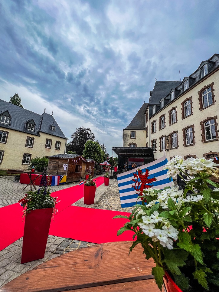 Exterior view of the European Business University Witz Campus With White Flower Decorations And Red Carpets