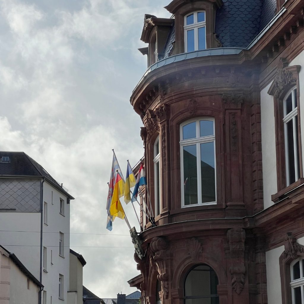 A building in Luxembourg with various flags hoisted