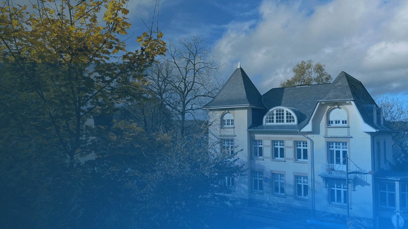 Banner with the text 'Free AI/Data Science Courses' in bold white letters, superimposed over a blurred background image of the EBU Campus Chateau with trees.