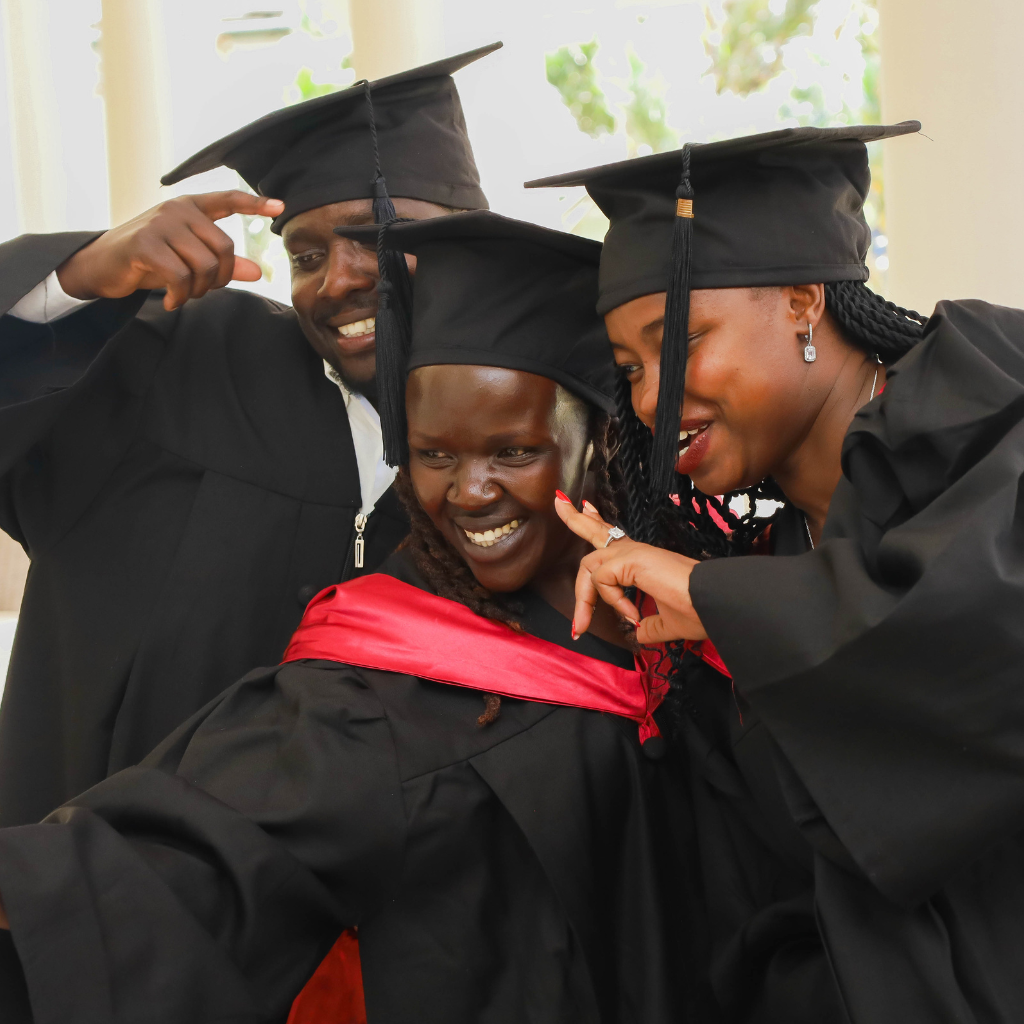 Studnets wearing graduation attires taking a picture together after their graduation with the European Business Institute of Luxembourg