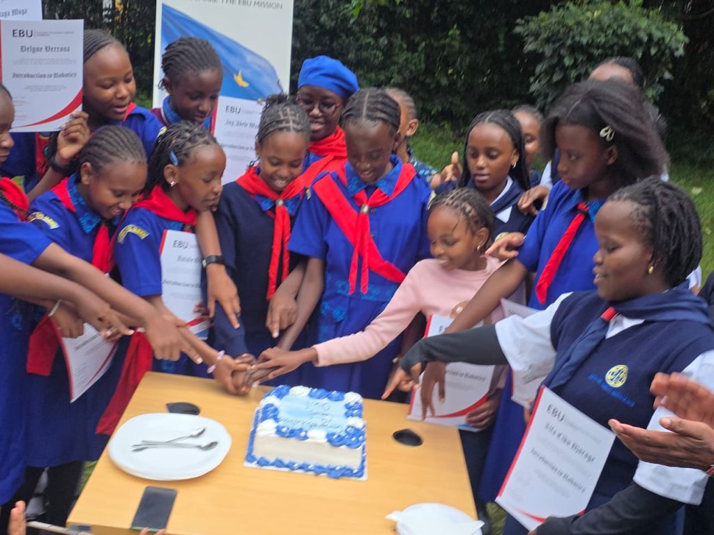 Cohort 1 students cutting cake to celebrate their certificates